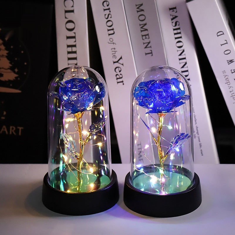 Rosa artificial luminosa decorativa en cúpula de plástico